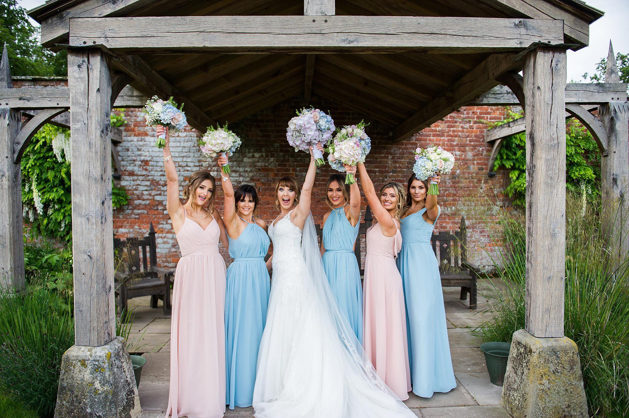A bridal party holding up bouquet